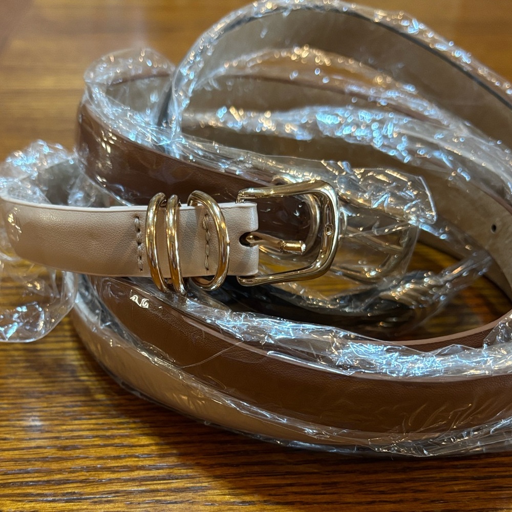 Three skinny belts, black, brown, and beige